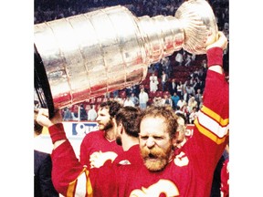Lanny McDonald holds the Stanley Cup after the Flames beat the Montreal Canadiens to capture the cup on May 25, 1989. Calgary Herald archives.