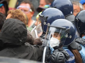 Police clash with demonstrators against COVID-19 vaccine mandates and restrictions gathered outside of the New Zealand Parliament grounds in Wellington on March 2, 2022.