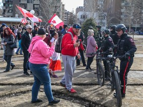 Calgary police clear Central Memorial Park following rallies by anti-mandate protesters and counter protesters on Saturday, March 19, 2022.