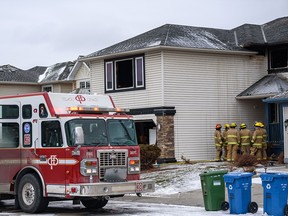 Calgary firefighters at the scene of a fatal fire at a home on Douglas Ridge Green S.E. on Feb. 18, 2022.