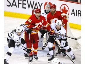 The Calgary Flames’ Matthew Tkachuk battles the Los Angeles Kings’ Tobias Bjornfot at the Scotiabank Saddledome in Calgary on Thursday, March 31, 2022.