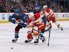 Calgary Flames forward Brett Ritchie skates for the puck against Colorado Avalanche forward Nazem Kadri at Ball Arena in Denver on March 13, 2022.