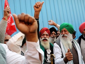 Farmers celebrate long-running protests being called off, after the Indian government agreed to their demands, including assurances to consider guaranteed prices for all produce, at the Singhu border protest site near the Delhi-Haryana border, India, December 9, 2021.
