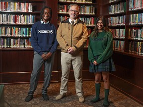 Strathcona Tweedsmuir School teacher Lennard Fink was photographed with students Bolu Kasumu, left, and Alia Nanji  at the school on Tuesday.