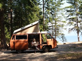 The author enjoying a morning read while camping in her 1983 Vanagon. Photo courtesy, Alex Berenyi