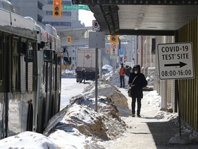 A person walks near the COVID-19 test site in downtown Winnipeg on March 7, 2022.