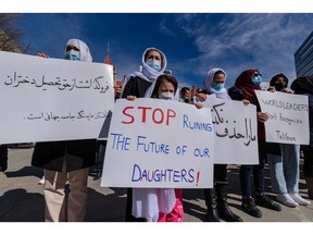 A group of Afghan newcomers gathers outside Calgary City Hall to protest against the Taliban for disallowing girls to go to school in Afghanistan on Monday, April 4, 2022. Despite the protest, Canada's interest in the fate of Afghanistan's women and girls has waned in recent times, writes Catherine Lang.