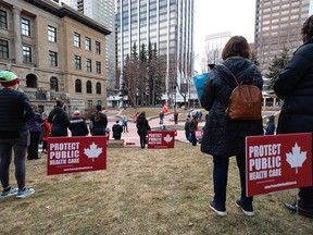 People gather outside the McDougall Centre in Calgary on Wednesday to rally in support of public health care following Dr. Verna Yiu’s early departure as CEO of Alberta Health Services.