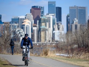 A cyclist spends the afternoon on the pathway along the Bow River on Monday, April 11, 2022.