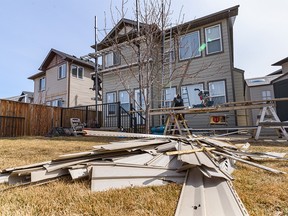 Workers with Risling Exteriors replace the vinyl sidings that were damaged by a hail storm with fibre cement sidings on a house in Skyview on Monday, April 18, 2022. Fibre cement sidings are more resistant to hail damage and fire.