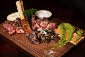 The massive Tomahawk steak with the bone left on. Azin Ghaffari/Postmedia
