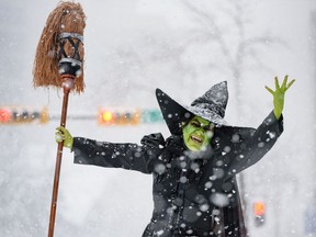 Cathy McLeod, aka Kraft Zombie, dressed as the Wicked Witch of the West from Wizard of Oz poses for a photo at the Parade of Wonders as cosplayers brave the heavy snow to participate in Calgary Comic and Entertainment Expo kick-off parade  on Friday, April 22, 2022.