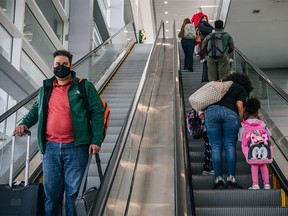 People travel through the George Bush Intercontinental Airport on December 3, 2021 in Houston, Texas.