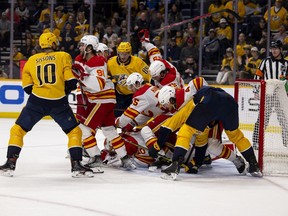 The Calgary Flames and Nashville Predators battle it out with Flames goalie Dan Vladar on the ice during their last encounter, at Bridgestone Arena in Nashville on April 19, 2022.