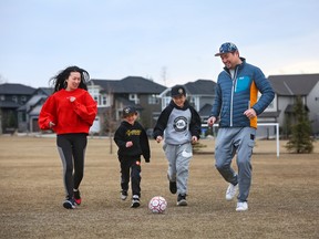 Hanh Chan plays soccer with her sons Cayman, 6, Kirin, 10, and her husband Kevin at a park in Legacy. The Hanhs are excited for the future middle school to be built in the open field within the next three years.