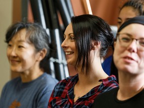 FILE PHOTO: Students listen as Kathy Kimpton, president, Women Building Futures speaks at a government announcement of $10 million over four years in funding for Women Building Futures in Edmonton, on Thursday, Sept. 19, 2019.