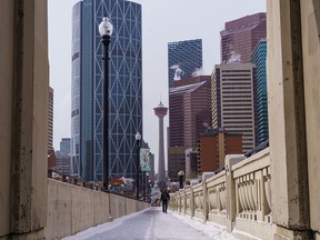 A man walks along centre street on a chilly day in Calgary on Thursday, April 14, 2022.