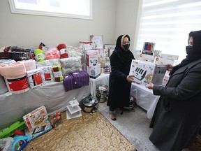 Volunteers with the Ahmadi Muslim Women of Calgary sort items such as crockery sets, kitchen electronics, blankets, pots and pans, and dishes purchased through their fundraising campaign to help families in Ukraine on Sunday, April 3, 2022.