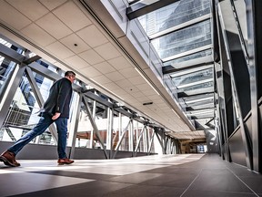 A downtown office worker walks through a quiet Plus-15 overpass in downtown Calgary on  Monday, April 4, 2022.