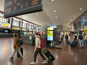 Passengers arrive at Via Rail at Central Station in Montreal. The core federal public service, air travel and rail employees must all be fully vaccinated against COVID-19.