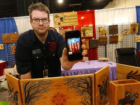 Matt Pickering of Pickering Woodworks shows a photo of his Captain America shield which was stolen at Calgary Expo at the on Sunday, April 24, 2022.