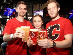 Preparations for a Flames playoff run are already underway at Trolley 5 on 17th Avenue S.W. Staff members Kyle Szoo, Maria Bravo and Drew Dougherty pose for a photo inside the brewery on Sunday, April 17, 2022.