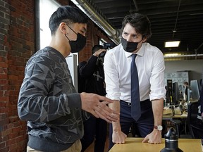 Prime Minister Justin Trudeau (right) speaks with an entrepreneur at Start Up Edmonton on Tuesday April 12, 2022. Prime Minister was in Edmonton to promote the 2022 federal budget. (PHOTO BY LARRY WONG/POSTMEDIA)