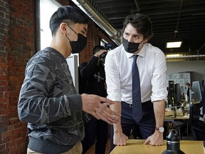 Prime Minister Justin Trudeau speaks with an entrepreneur at Start Up Edmonton on Tuesday, April 12, 2022. Trudeau was in Edmonton to promote the 2022 federal budget.