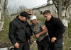 Members of security forces help an injured man following Russia's bombing of a factory in Kramatorsk, eastern Ukraine, April 19, 2022.