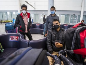 Students from India wait at international arrivals at Terminal 1 at Toronto's Pearson International Airport on Sunday Dec. 27, 2020. International students have had a particularly tough time in Canada during the pandemic.