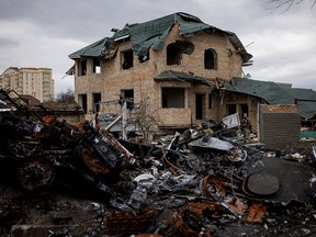 Ukrainian soldiers inspect a destroyed house in Bucha, northwest of Kyiv, Ukraine, on April 6, 2022.