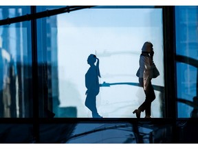 Office workers walk through a plus 15 in downtown Calgary on Thursday, March 10, 2022.