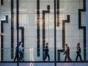 Office workers walk through Brookfield Place in downtown Calgary on Thursday, March 10, 2022. 