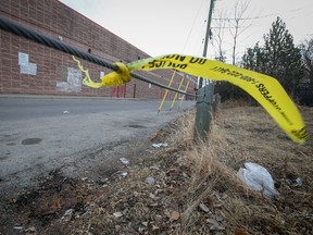 Left over police tape remains near a homicide scene in an alley behind the 200 block of 16th avenue N.W. on Saturday, April 2, 2022. One man was shot while in a vehicle in the alley at about 8:30 pm on Friday evening.