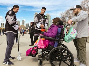 Calgary Roughnecks Harrison Matsuoka, left and Reece Callies greeted visitors at the Autism Awareness and Acceptance Day at the Calgary Stampede Youth Campus in Calgary on Saturday, April 2, 2022.