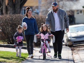 Ukrainian refugees Yuliia and Oleksandr Hriebieniuk walk with their daughters; Danea, 3, left and Yeva, 4 in Calgary's Wildwood neighbourhood on Saturday, April 30, 2022.