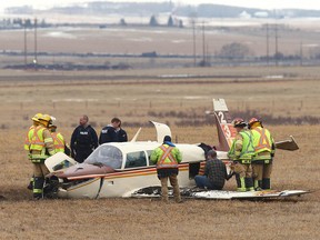 Emergency crews at the scene of a plane crash near Springbank Airport west of Calgary on Friday, April 22, 2022.