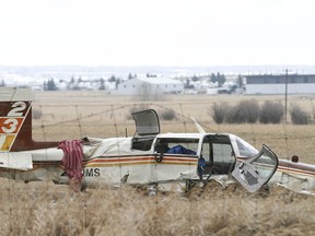 Damage to a small aircraft is shown at the scene of a plane crash near Springbank Airport west of Calgary on Friday, April 22, 2022.