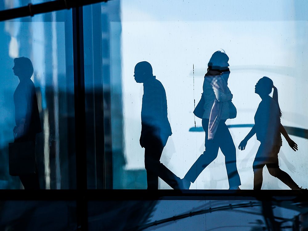 Office workers walk through a plus-15 in downtown Calgary on Thursday, March 10, 2022.