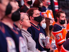Hockey fans, some masked, some not, attend an Edmonton Oilers game at Rogers Place on Feb. 9, 2022.