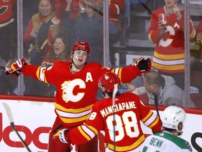 Flames forward Matthew Tkachuk celebrates his 100th point on the season during the second period of Thursday night's game against the Dallas Stars at the Scotiabank Saddledome. The Flames won 4-2.
