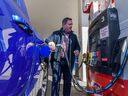 Prime Minister Jason Kenney fills up his truck with gasoline after a press conference at the Cooperative on Macleod Trail SE on Friday April 1, 2022. Alberta has temporarily cut 13 cents off the price of a liter of gasoline.
