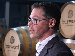 Doug Schweitzer, minister of Jobs, Economy and Innovation, speaks at Burwood Distillery in Calgary as the province announces $66 million for tourism recovery on Friday, April 22, 2022.