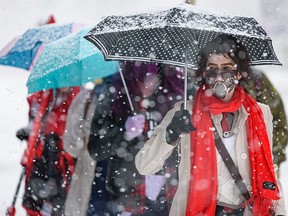 Megan Einarson, dressed as Viktor from Arcane, takes part in the Calgary Expo Parade of Wonders during a snowstorm on Friday, April 22, 2022.