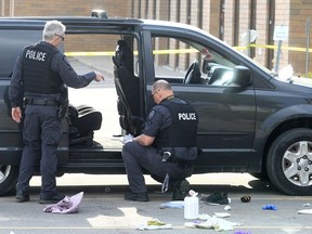 Police investigate the scene of a stabbing in the parking lot of Tecumseh Tae Kwon Do on April 29, 2022.