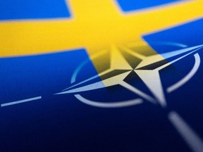 Swedish and NATO flags are seen printed on paper this illustration taken April 13.