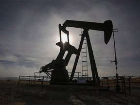 A pumpjack works at a well head on an oil and gas installation near Cremona, Alta., Saturday, Oct. 29, 2016.