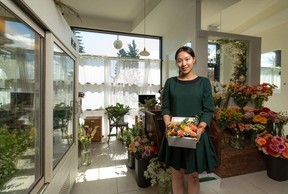 And Some Flower Cafe owner Raina Moon with a flower box for Mother's Day.  Azin Ghaffari/Postmedia