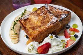 Weekend French Toast beautifully plated with fruit and flowers at And Some Flower Cafe.  Azin Ghaffari/Postmedia