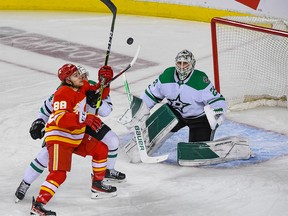 Calgary Flames Andrew Mangiapane against Dallas Stars Joel Hanley and goaltender Jake Oettinger during the first period of Game 7 of the first round of playoff action at the Scotiabank Saddledome on Sunday, May 15, 2022.
